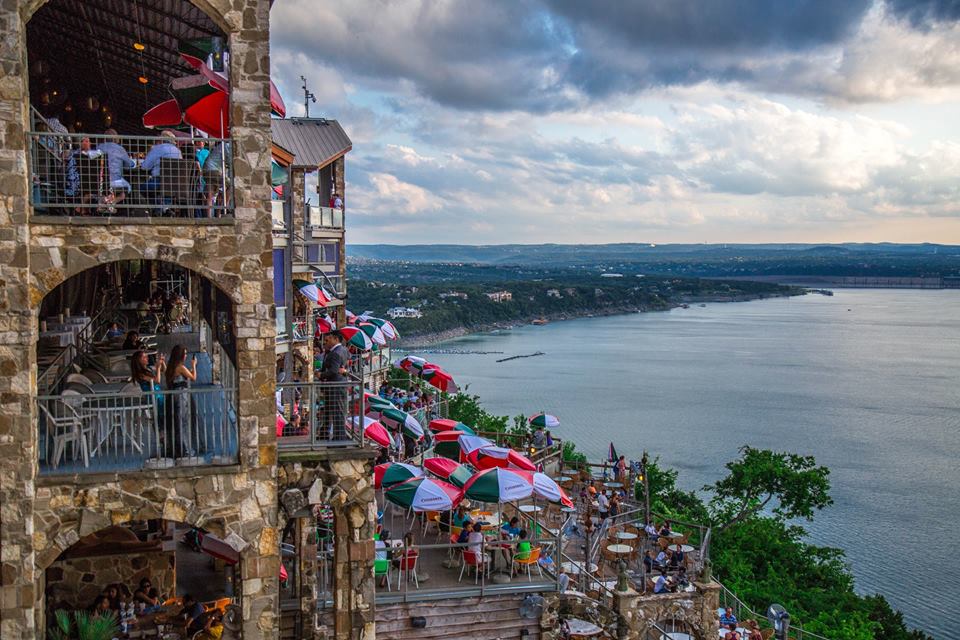 At the Oasis on Lake Travis guest take pictures of the sunset